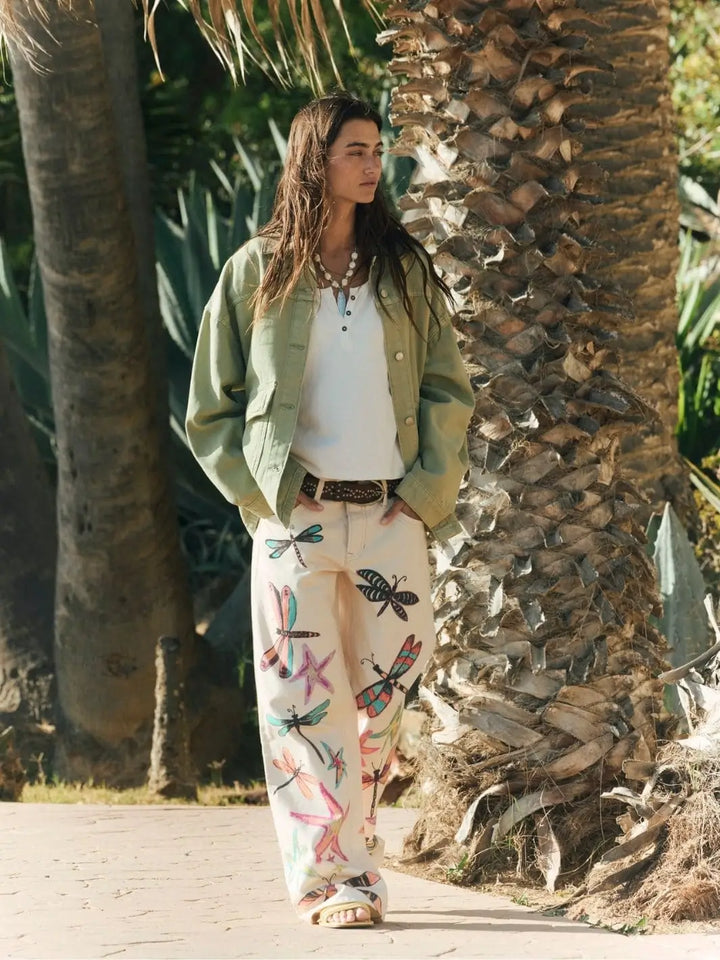 A full-length outdoor view showcases the relaxed, casual styling and oversized fit of the Free People Lemon Denim Jacket in Washed Sage | Twentyseven Toronto