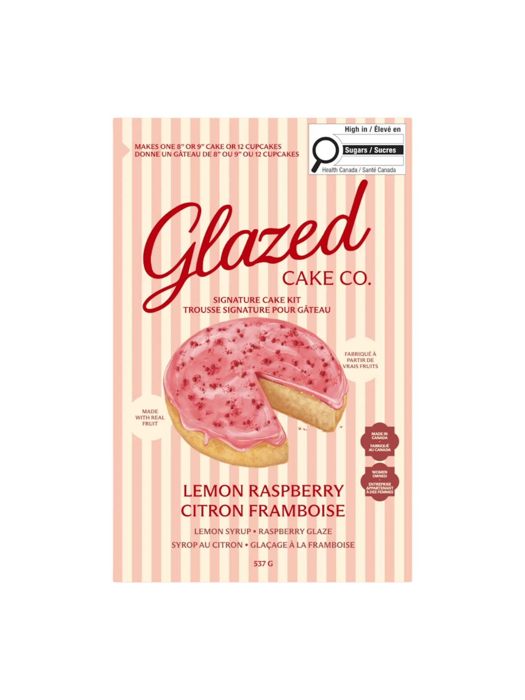 The front of a pink and cream striped box displays the product packaging for the Glazed Cake Co Lemon Raspberry Cake Kit with an illustration of a sliced lemon cake | Twentyseven Toronto