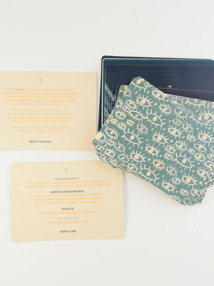 Two instructional cards explaining how to use the deck lay next to a stack of patterned cards from the Letting Your Shadow In Deck from People I've Loved | Twentyseven Toronto
