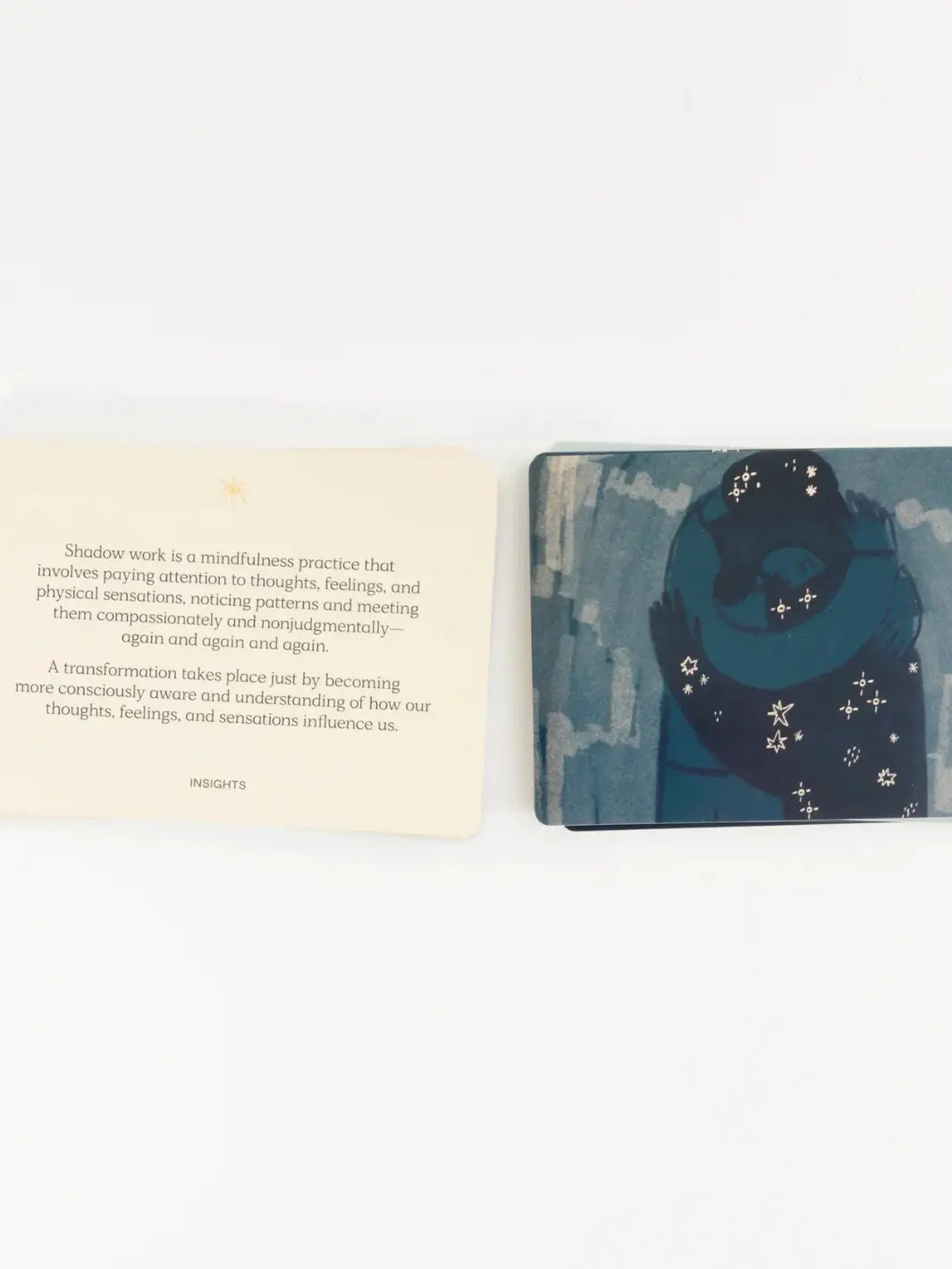 An open-faced insight card sits next to an illustrated card depicting a starry embrace from the Letting Your Shadow In Deck from People I've Loved | Twentyseven Toronto