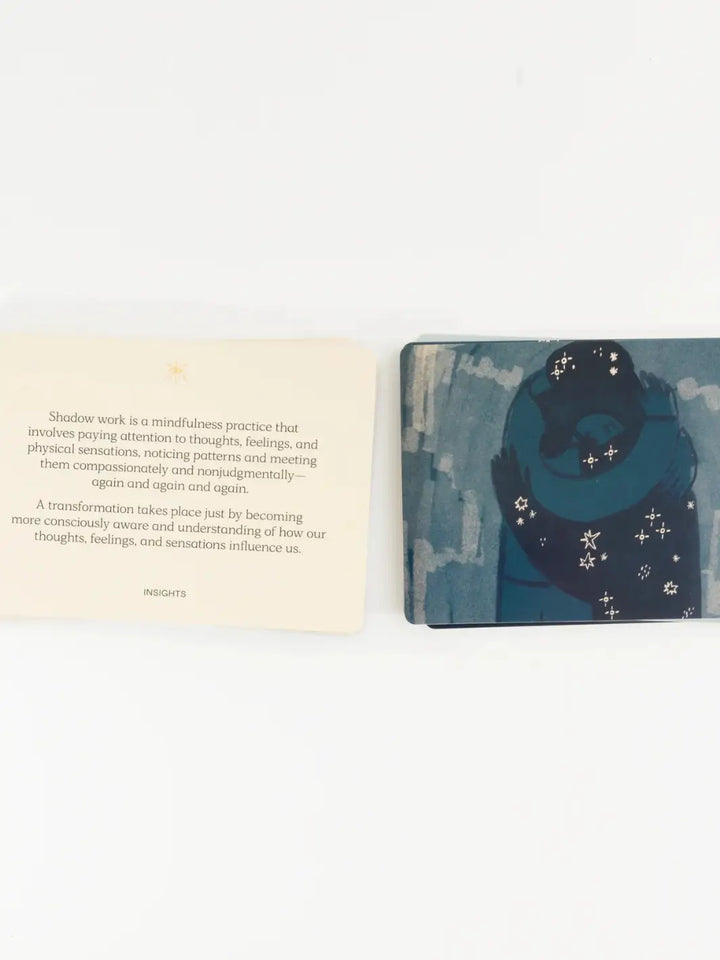 An open-faced insight card sits next to an illustrated card depicting a starry embrace from the Letting Your Shadow In Deck from People I've Loved | Twentyseven Toronto