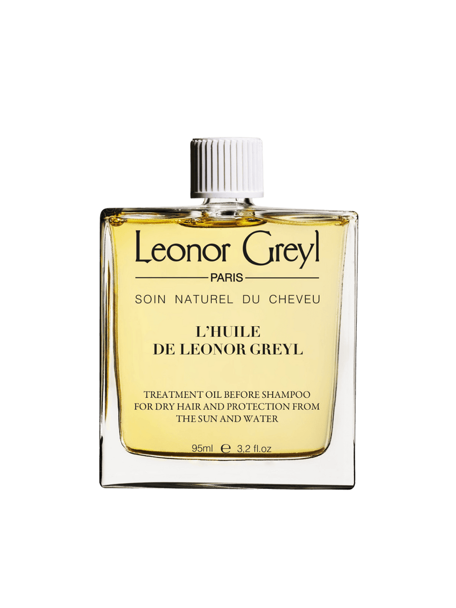 Glass bottle of gold liquid 'L’Huile de Leonor Greyl' by Leonor Greyl on a transparent background | Twentyseven Toronto