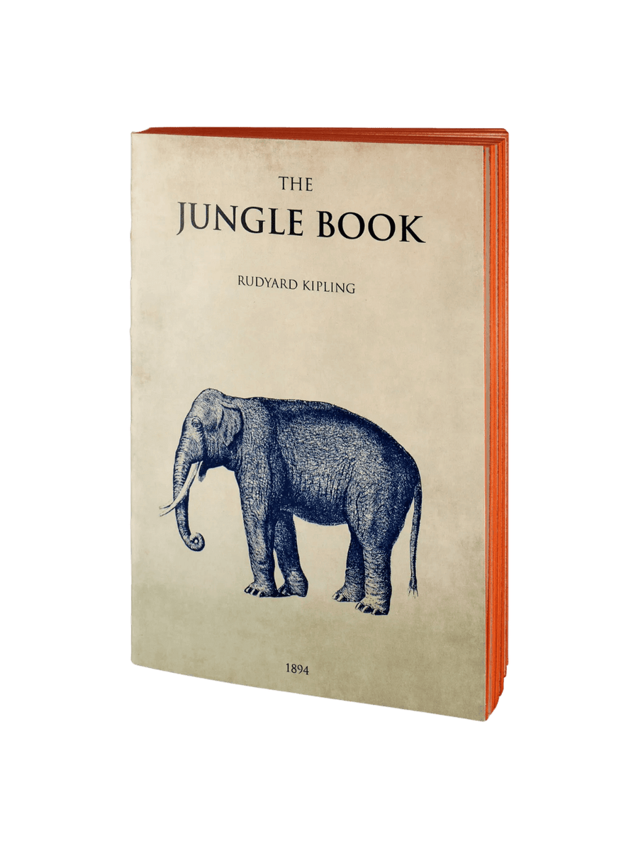 The cream-colored front cover The Jungle Book notebook from the Slow Design Libri Muti collection features the title and author printed above a detailed blue illustration of an elephant, revealing vibrant orange hand-painted page edges | Twentyseven Toronto