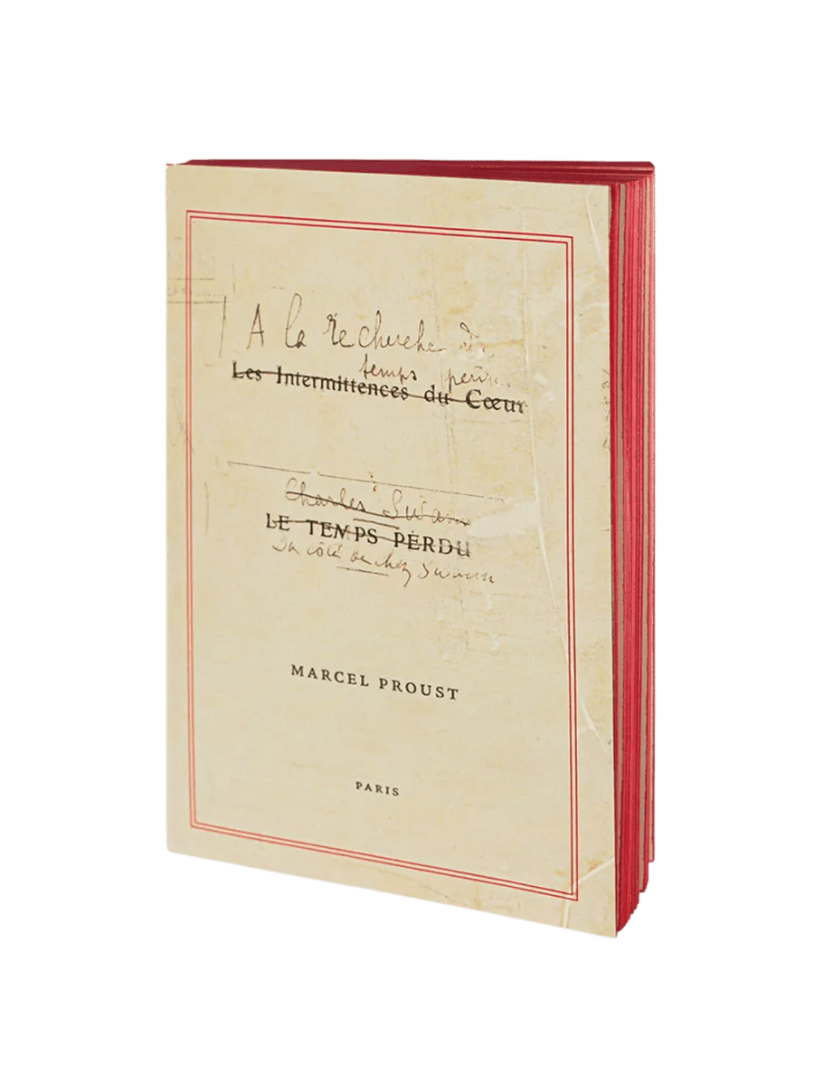 Notebook titled 'À la Recherche du Temps Perdu' by Marcel Proust from the Slow Design Libri Muti collection with red binding on a transparent background | Twentyseven Toronto