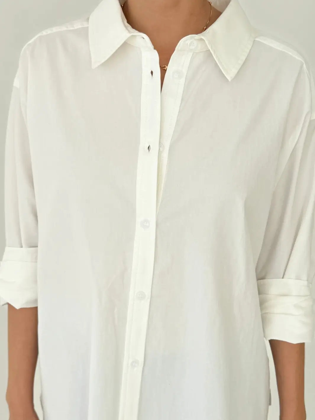 Close up shot of a person wearing a button up 'Light Weight Owen Shirt' in 'White' from Le Bon Shoppe against a neutral background | Twentyseven Toronto