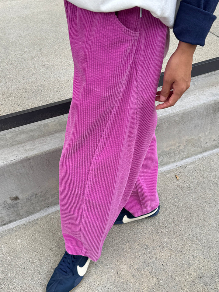 Le Bon Shoppe Soft Corduroy Arc Pants in Lilac worn outdoors, side view showing curved leg and pocket | Twentyseven Toronto