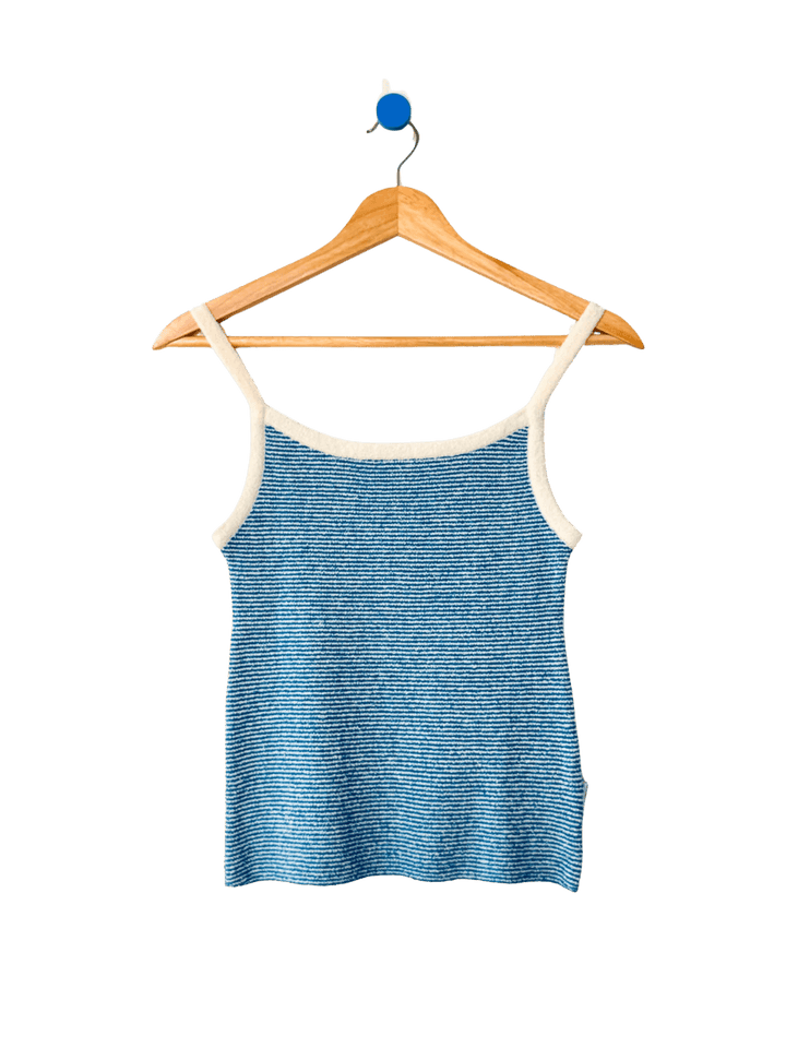 Light blue 'Lily Sweater Cami' tank top in 'Blue Stripe' design with white trim from Le Bon Shoppe on a wooden hanger against a transparent background | Twentyseven Toronto