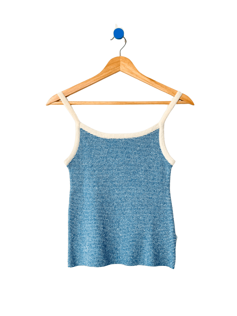 Light blue 'Lily Sweater Cami' tank top in 'Blue Stripe' design with white trim from Le Bon Shoppe on a wooden hanger against a transparent background | Twentyseven Toronto