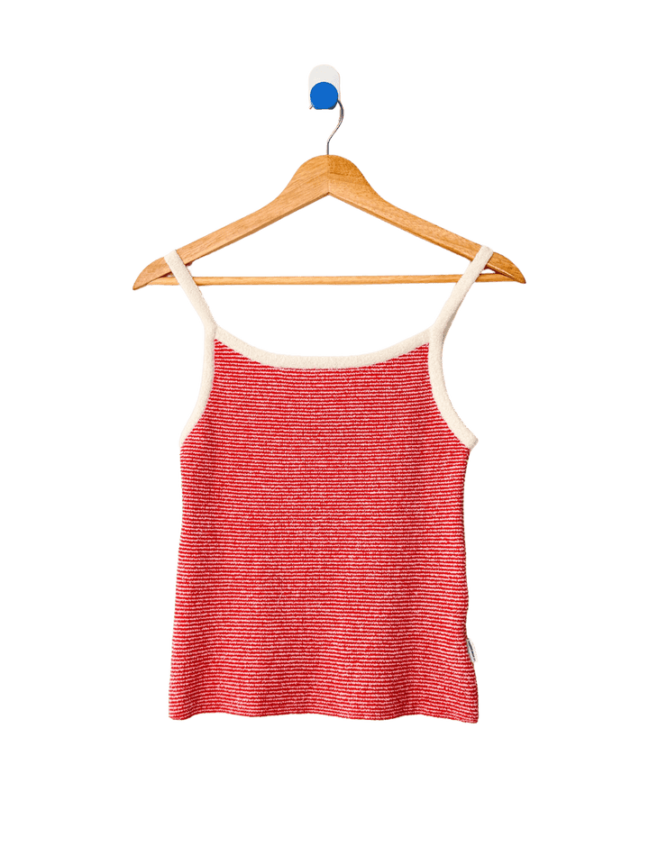 Red 'Lily Sweater Cami' tank top in 'Red Stripe' design with white trim from Le Bon Shoppe on a wooden hanger against a transparent background | Twentyseven Toronto