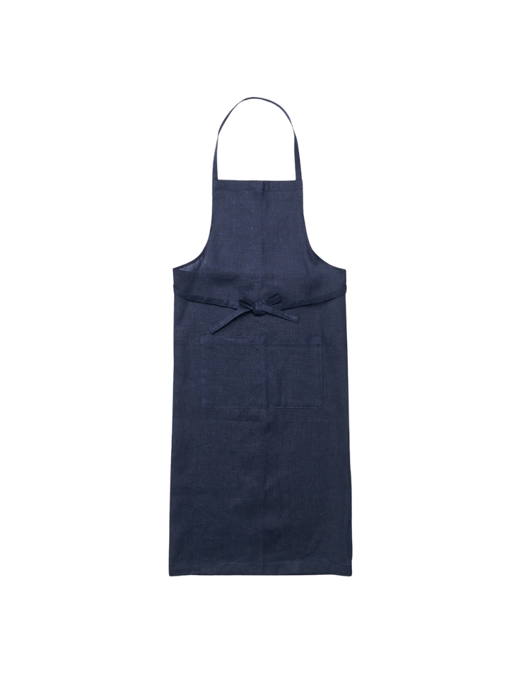 The Linen Full Apron in Navy from Fog Linen Work laid flat against a transparent background to show its classic silhouette and deep blue colour | Twentyseven Toronto