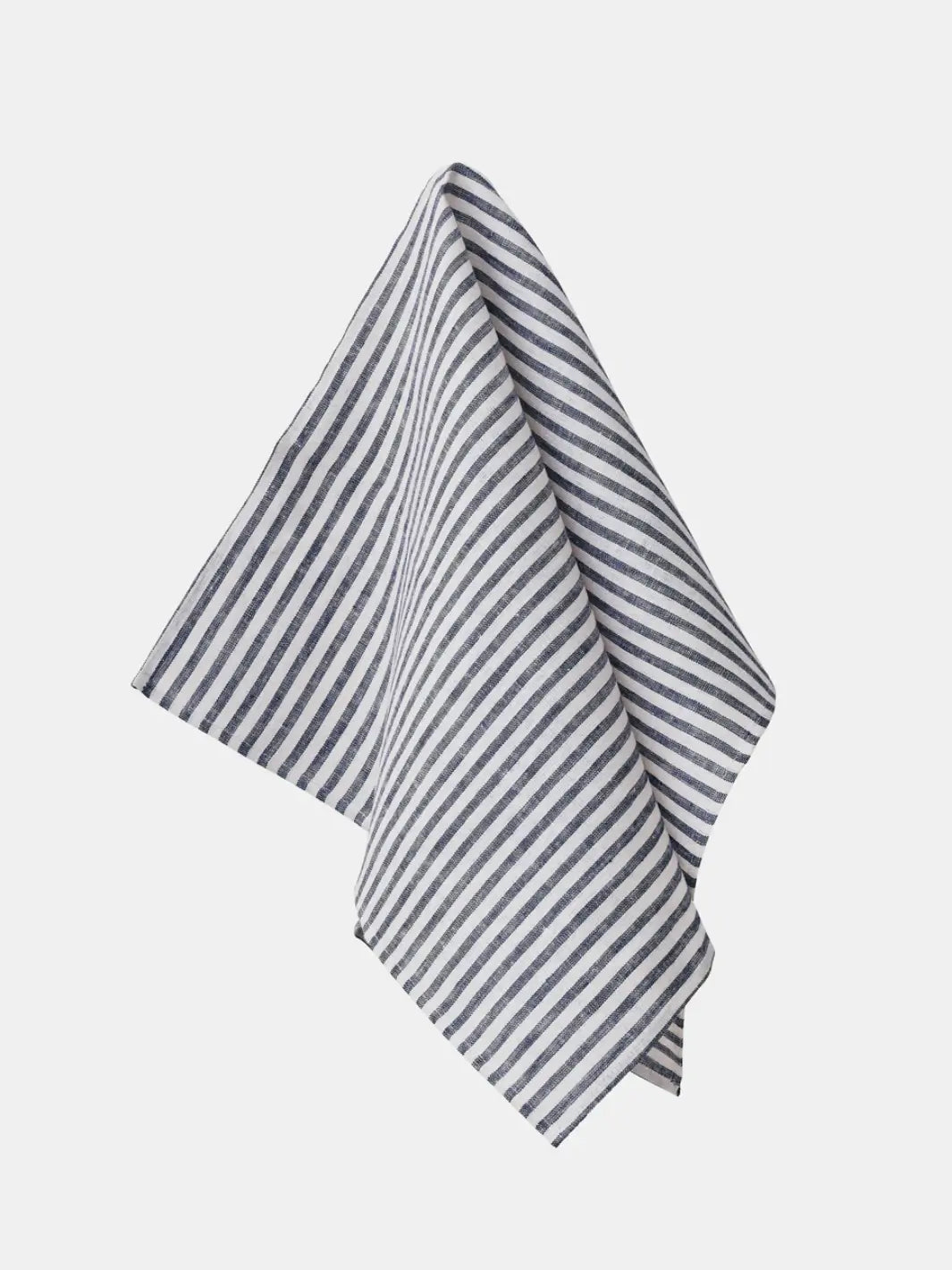 A Fog Linen Work Linen Kitchen Cloth - Jasper with navy blue and white vertical stripes hangs elegantly against a plain white background | Twentyseven Toronto