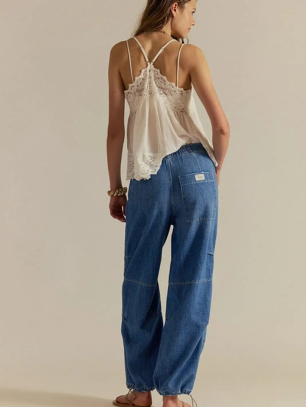 A rear view shot highlights the elastic waistband, large patch pocket, and relaxed fit of the Free People Logan Cinched Cargo Jeans - Harper | Twentyseven Toronto