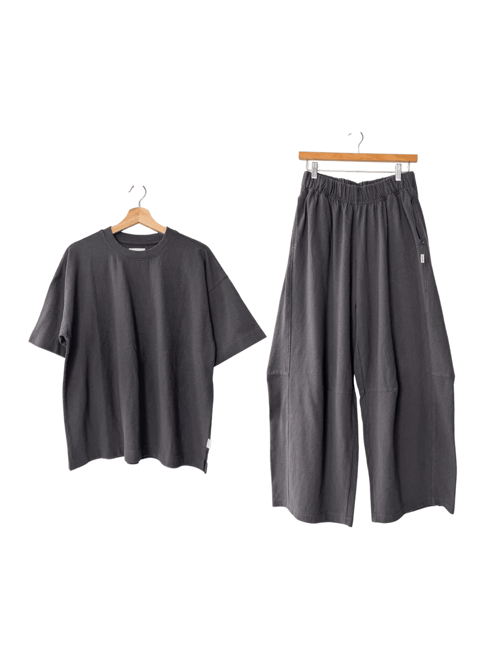 Le Bon Shoppe Jayden Tee in 'Dark Slate' t-shirt and Bare Pants in 'Dark Slate' wide-leg pants on hangers | Twentyseven Toronto