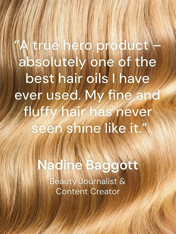 A detailed close-up of radiant, wavy blonde hair features a positive testimonial from beauty journalist Nadine Baggott praising the Hair by Sam McKnight Love Me Do Nourishing Shine Oil | Twentyseven Toronto