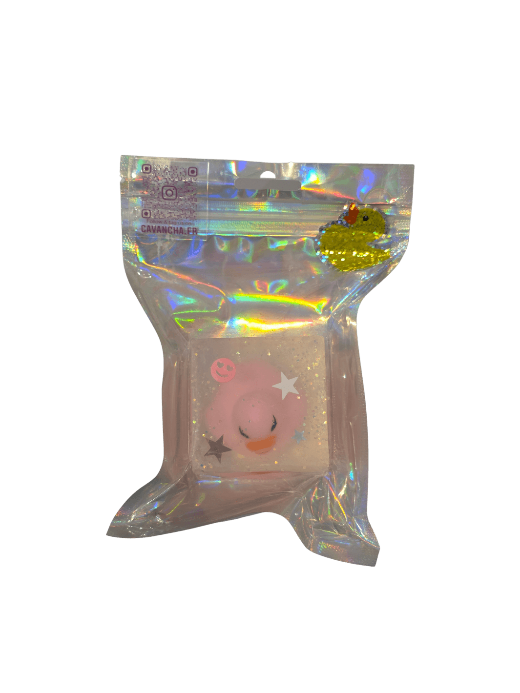 A clear bar of Cavancha Magic Glitter Soap - Ducky, embedded with a small pink duck charm, star glitter, and a tiny smiley face, packaged inside a shiny holographic pouch | Twentyseven Toronto