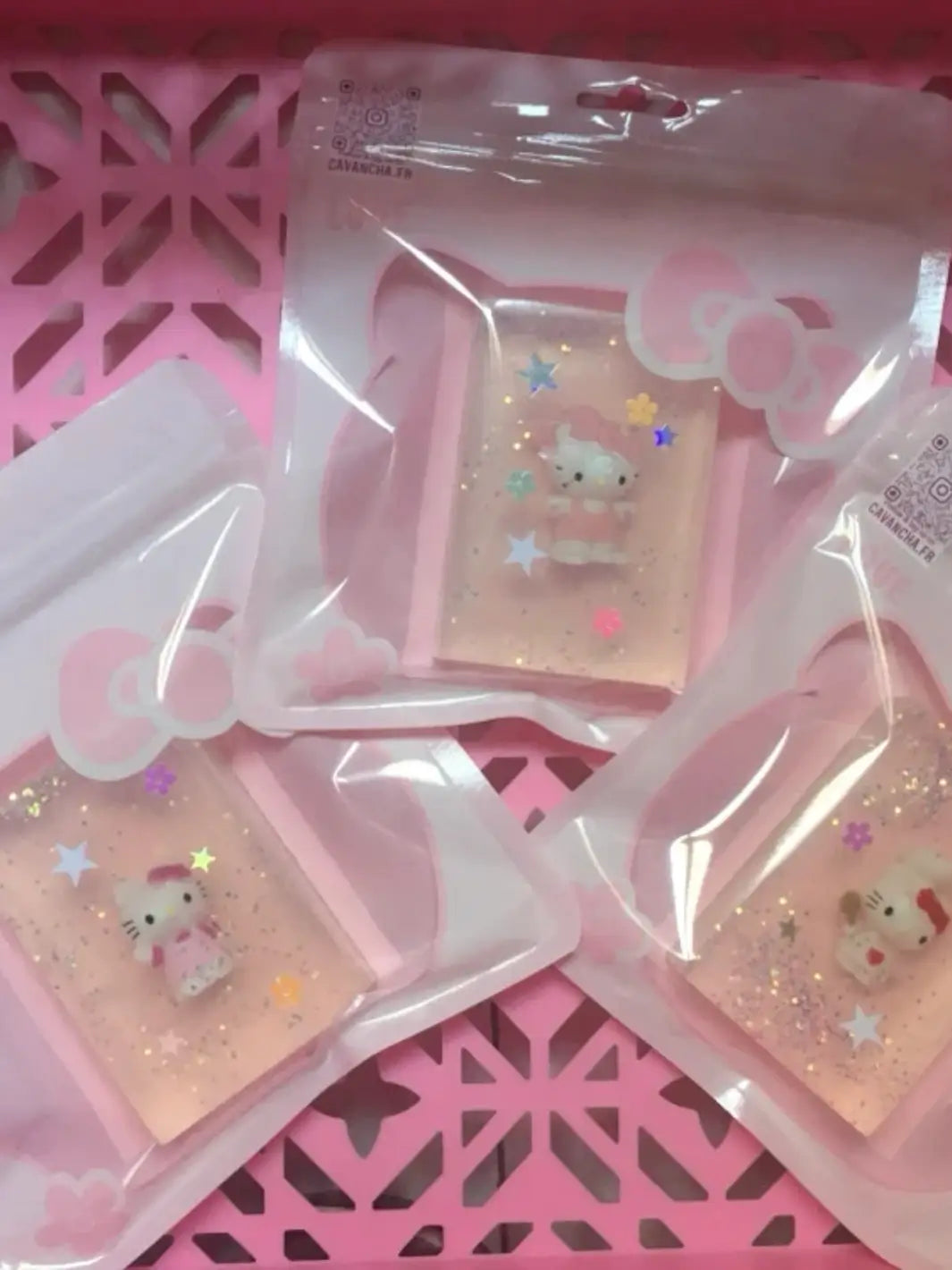 Three individually packaged bars of clear Cavancha Magic Glitter Soap - Hello Kitty are arranged inside a pink decorative plastic basket | Twentyseven Toronto