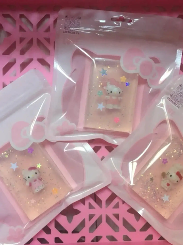 Three individually packaged bars of clear Cavancha Magic Glitter Soap - Hello Kitty are arranged inside a pink decorative plastic basket | Twentyseven Toronto