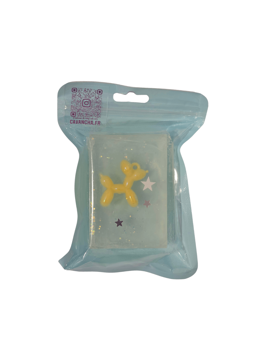 A clear bar of Cavancha Magic Glitter Soap - Jeff, containing a small yellow balloon dog charm and embedded star glitter, packaged inside a light blue pouch | Twentyseven Toronto