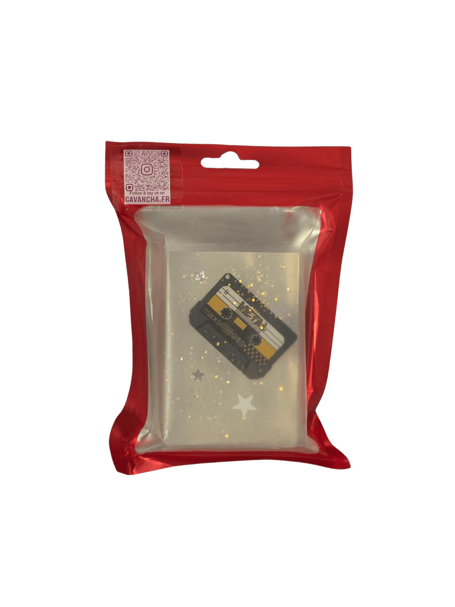A clear bar of Cavancha Magic Glitter Soap - Rock, embedded with a miniature black cassette tape and silver star glitter, packaged inside a red ziplock pouch | Twentyseven Toronto