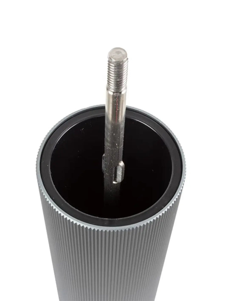 Metallic cylindrical object with a rod inside for Peugeot on a white background | Twentyseven Toronto