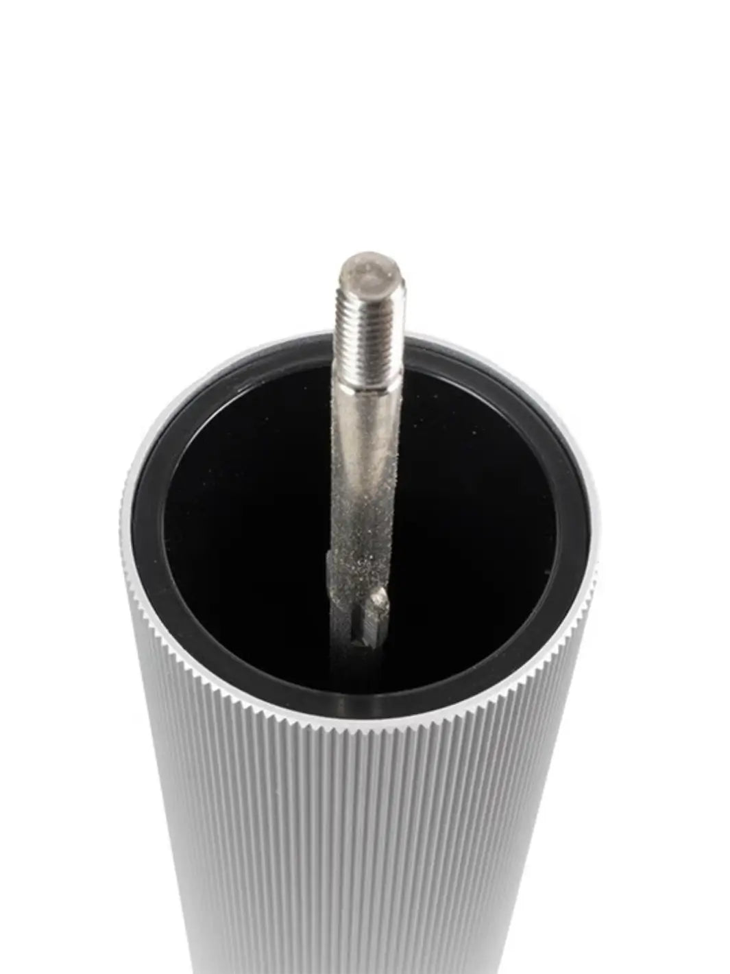 Metallic cylindrical object with a threaded rod from Peugeot on a white background | Twentyseven Toronto