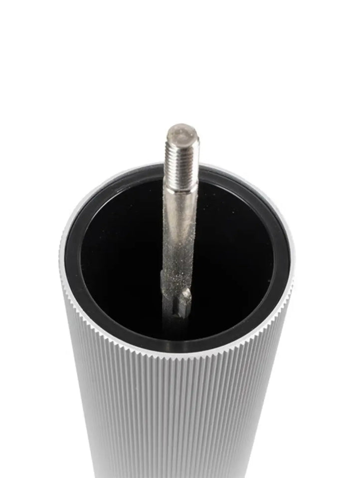 Metallic cylindrical object with a threaded rod from Peugeot on a white background | Twentyseven Toronto
