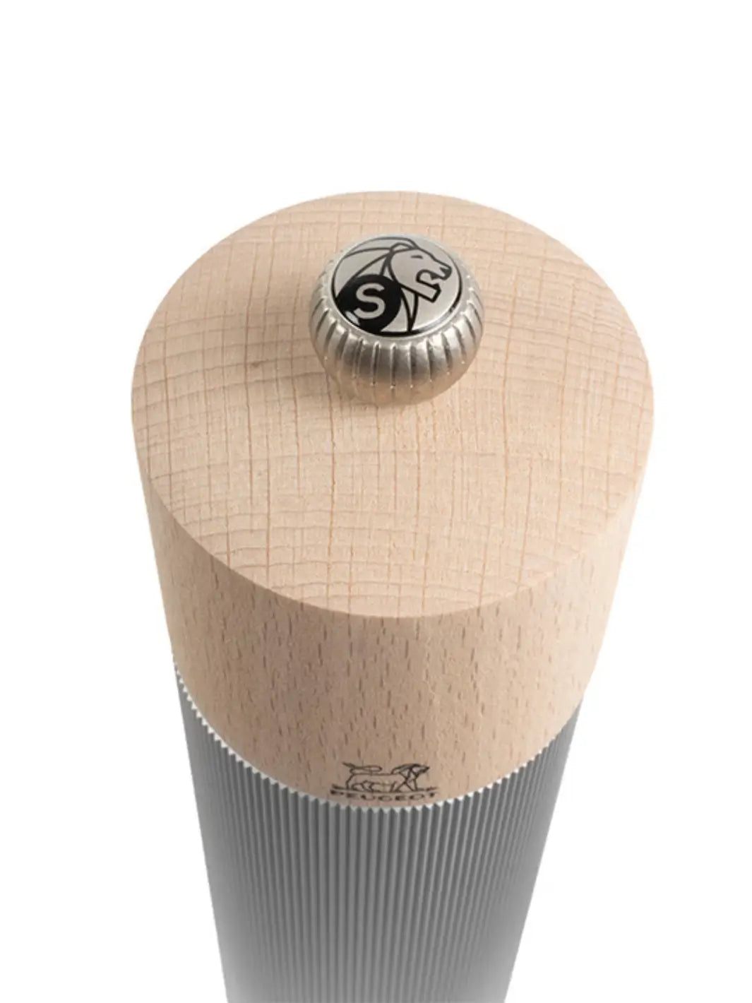 Wooden pepper grinder with metallic top from Peugeot on a white background | Twentyseven Toronto