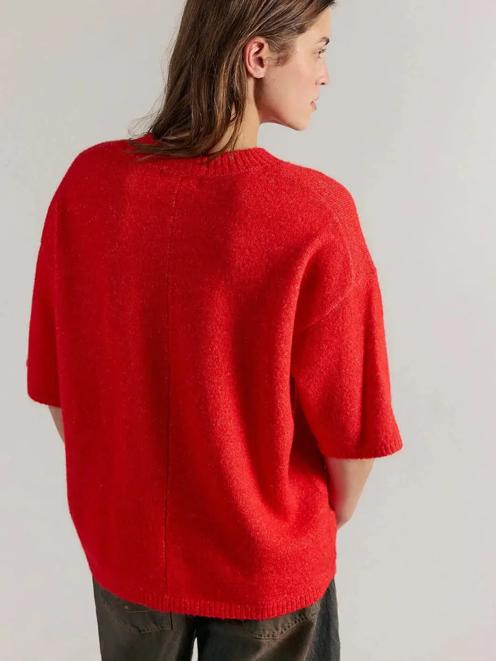 A three-quarter rear view displays the vertical center-back seam and relaxed, short-sleeve construction of the Free People Margot SoftSpun Sweater Tee in Cherry Pop Melange | Twentyseven Toronto