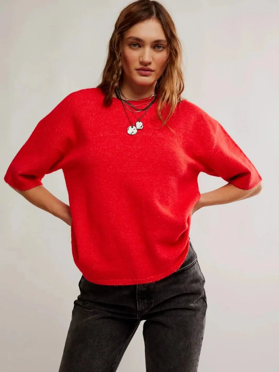 A side profile view emphasizes the slouchy, dropped-shoulder silhouette and elongated short sleeves of the Free People Margot SoftSpun Sweater Tee in Cherry Pop Melange | Twentyseven Toronto