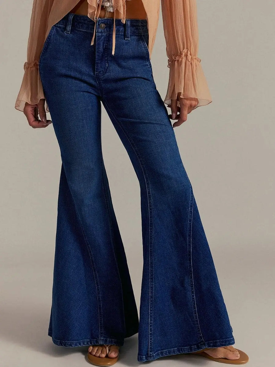A front view highlights the high-rise waist and exaggerated, wide-leg design of the Free People Marque Flare Jeans - Kora | Twentyseven Toronto