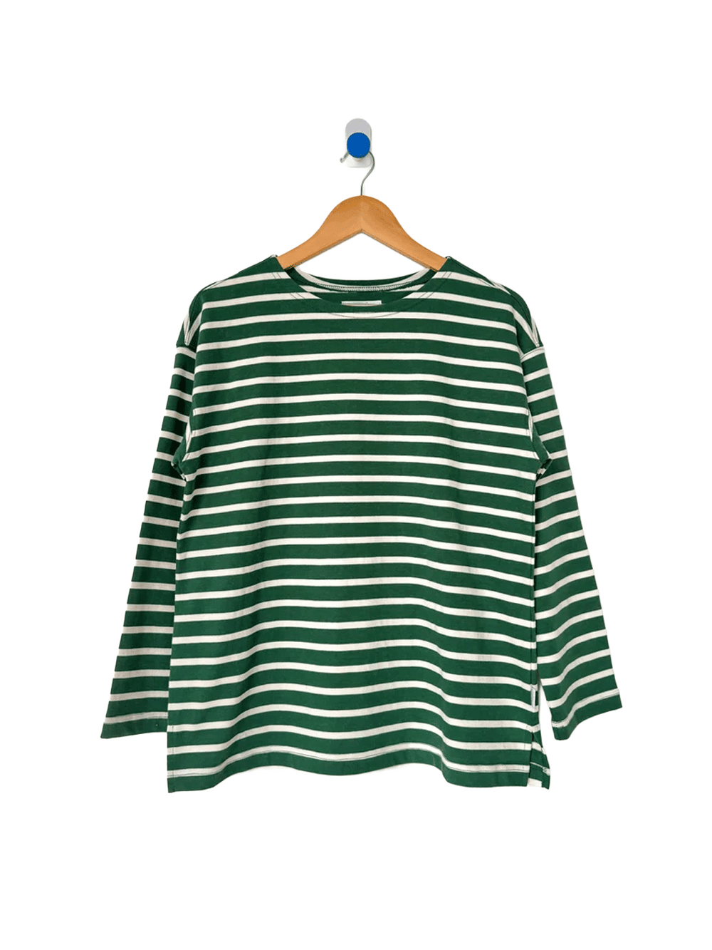 Marseille Top in White Stripe on Pine hanging on a wooden hanger, featuring green and white Breton stripes, a round neckline and relaxed long sleeves | Twentyseven Toronto