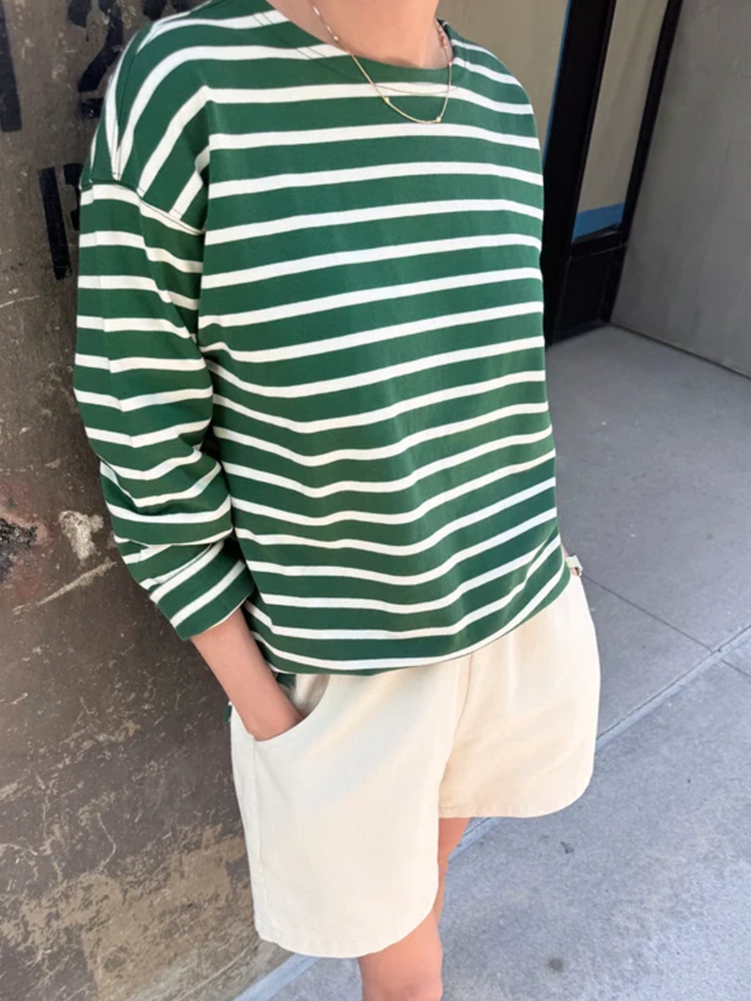 Close-up of the Marseille Top in White Stripe on Pine, showing its heavyweight cotton fabric, green and white horizontal stripes and relaxed oversized fit | Twentyseven Toronto