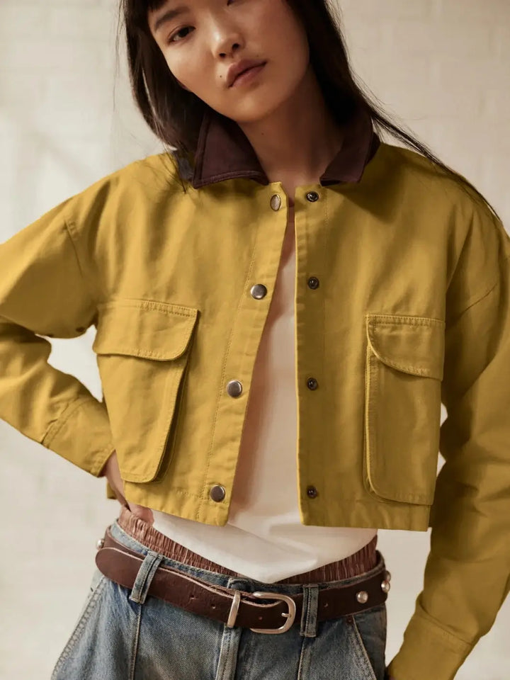 A mid-section front view highlights the boxy, cropped fit and structured flap pockets of the unbuttoned Free People Martha Workwear Applique Jacket in Rattan | Twentyseven Toronto