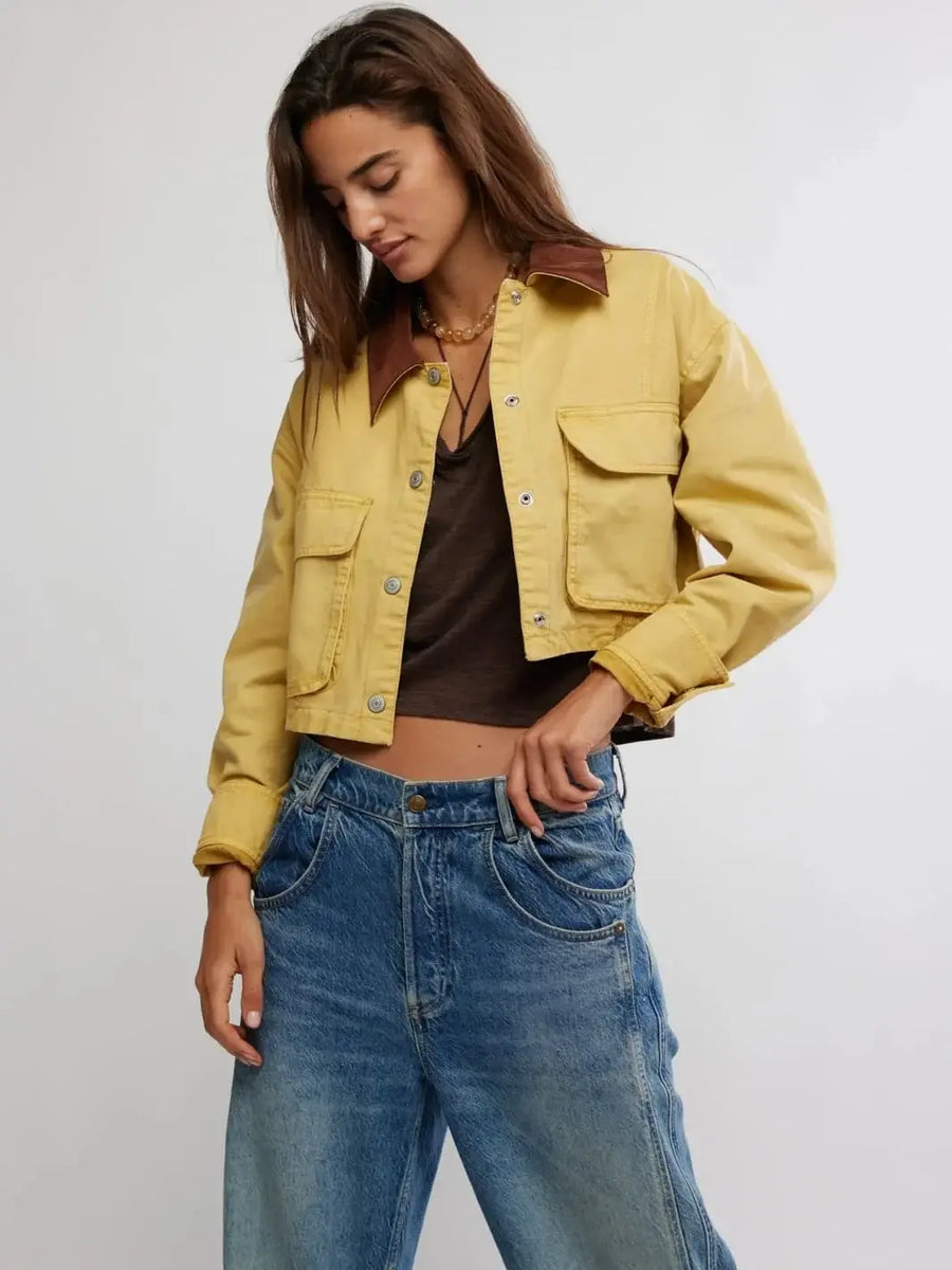 A front view showcases the relaxed fit and distinct panel stitching of the Free People Martha Workwear Applique Jacket in Rattan layered over a brown tank top and blue jeans | Twentyseven Toronto