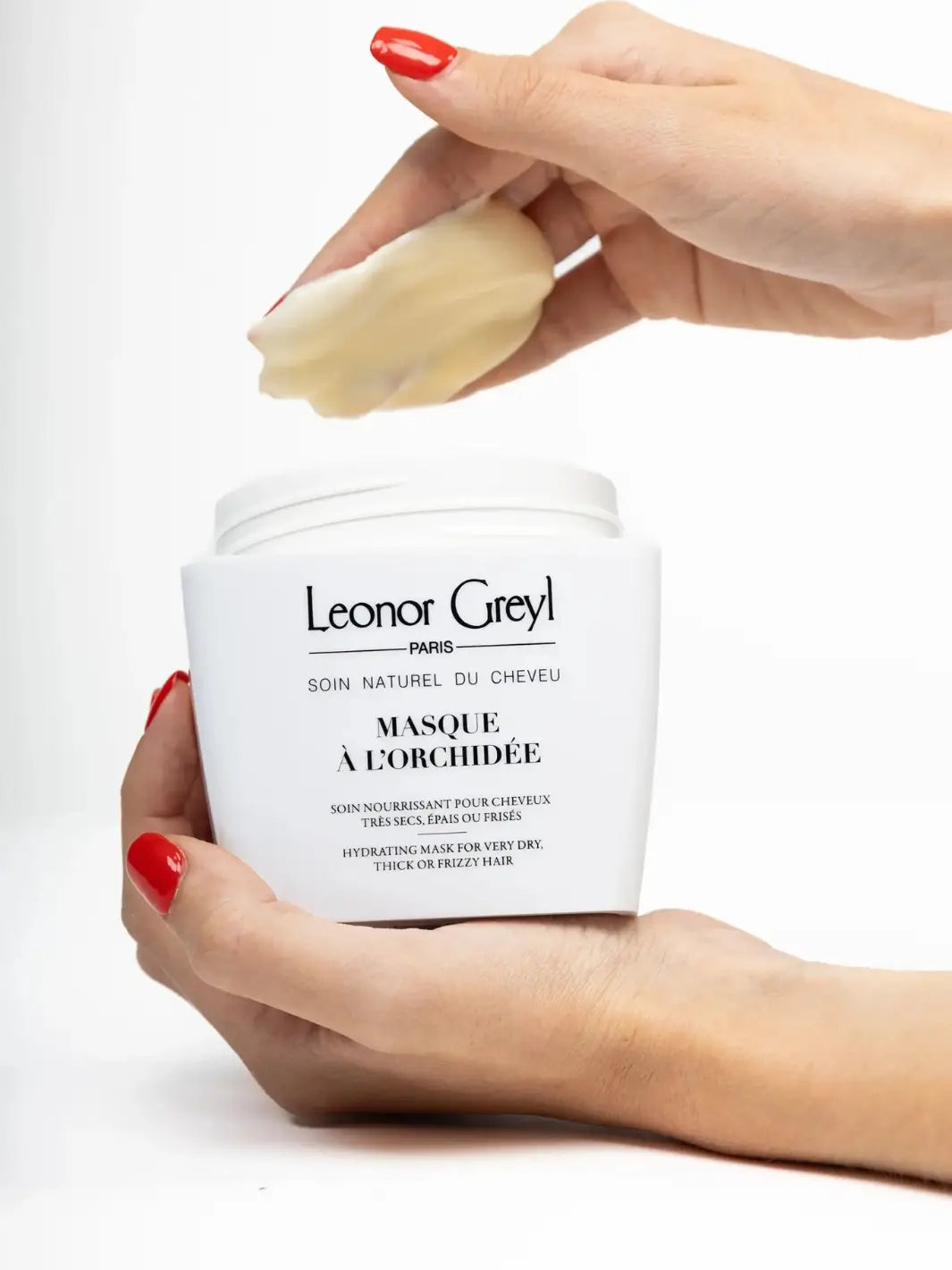 Close-up of Leonor Greyl 'Masque à l’Orchidée' white cream texture swatch on a light beige background | Twentyseven Toronto