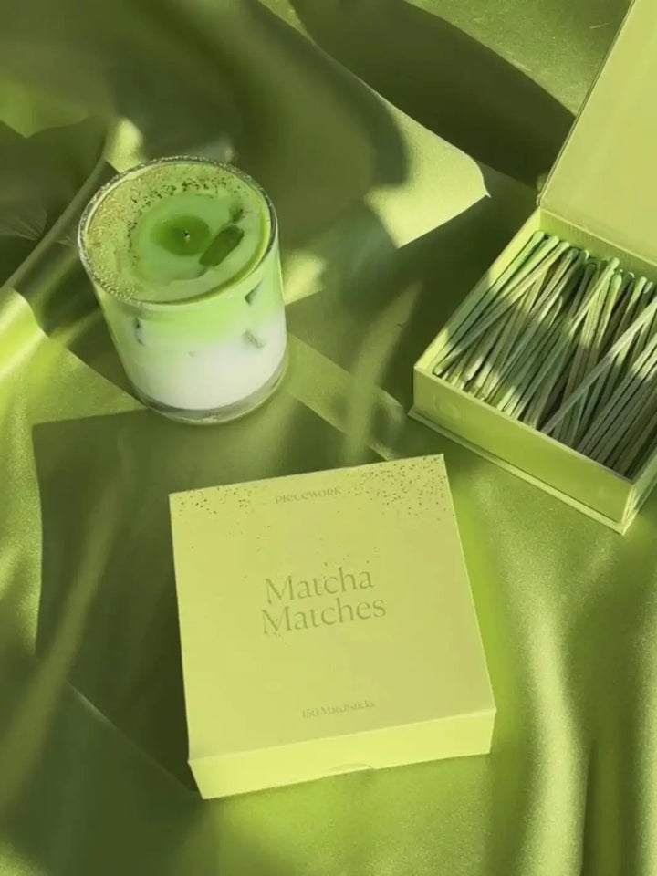 Light green box, one open one closed, labeled 'Matcha Matches" with a green candle on a light green background | Twentyseven Toronto