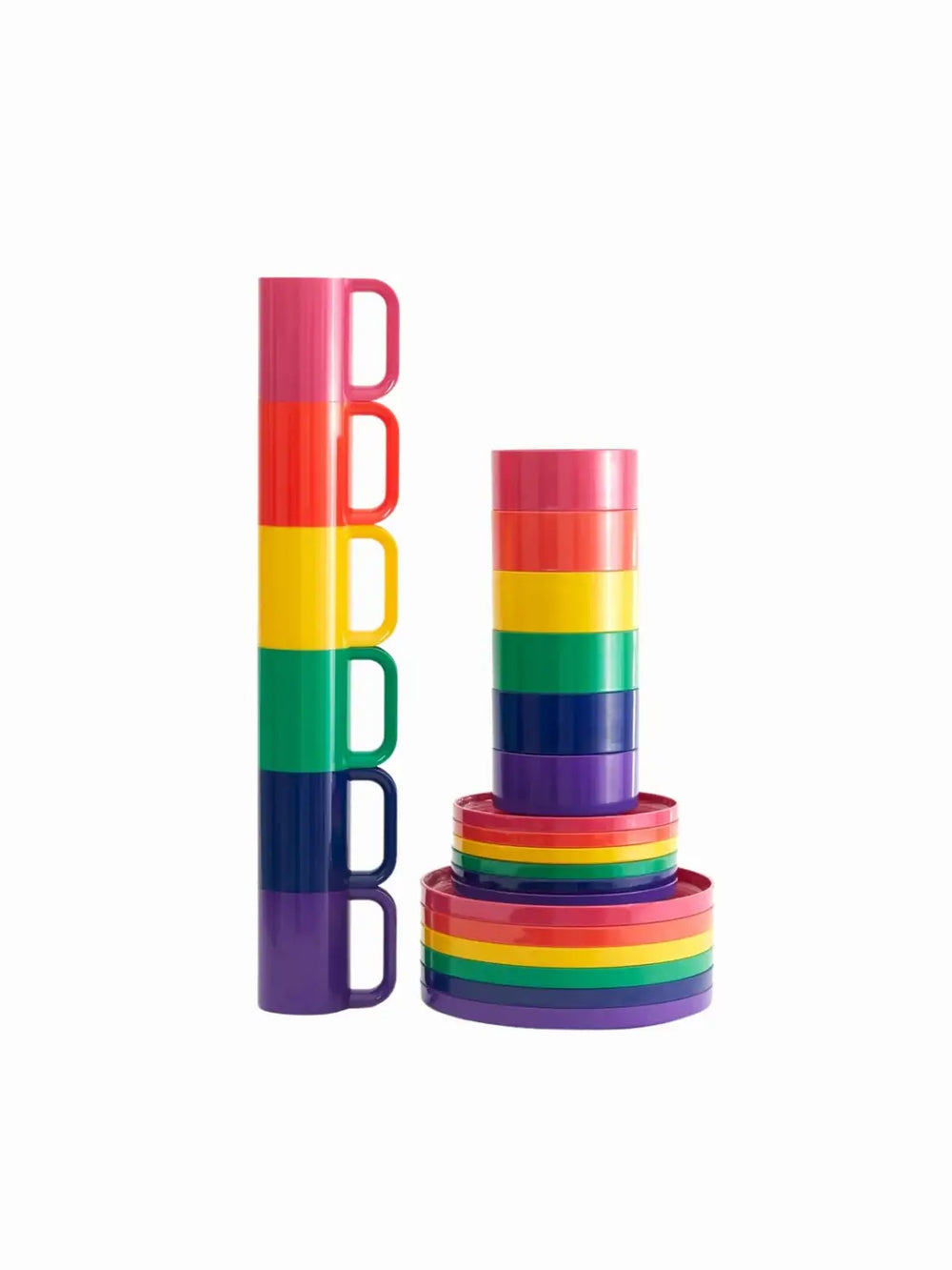 A stack of rainbow drinkware stands next to a matching rainbow stack of dinnerware plates, salad plates, and bowls from the Heller Max Dinnerware Set in Rainbow against a clean white background | Twentyseven Toronto