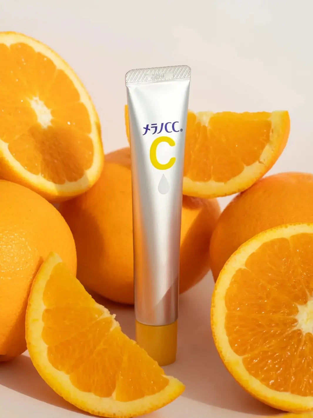 Tube of Rohto Mentholatum Melano CC Medicated Spot Treatment Serum with oranges on a light background | Twentyseven Toronto