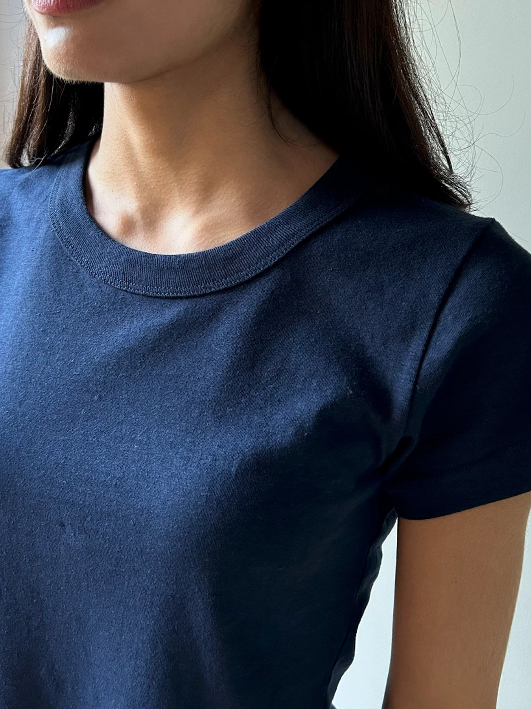 Close-up of the Hemp Mini Tee in Navy featuring a fitted silhouette, ribbed crew neckline and short sleeves in a hemp and organic cotton blend | Twentyseven Toronto