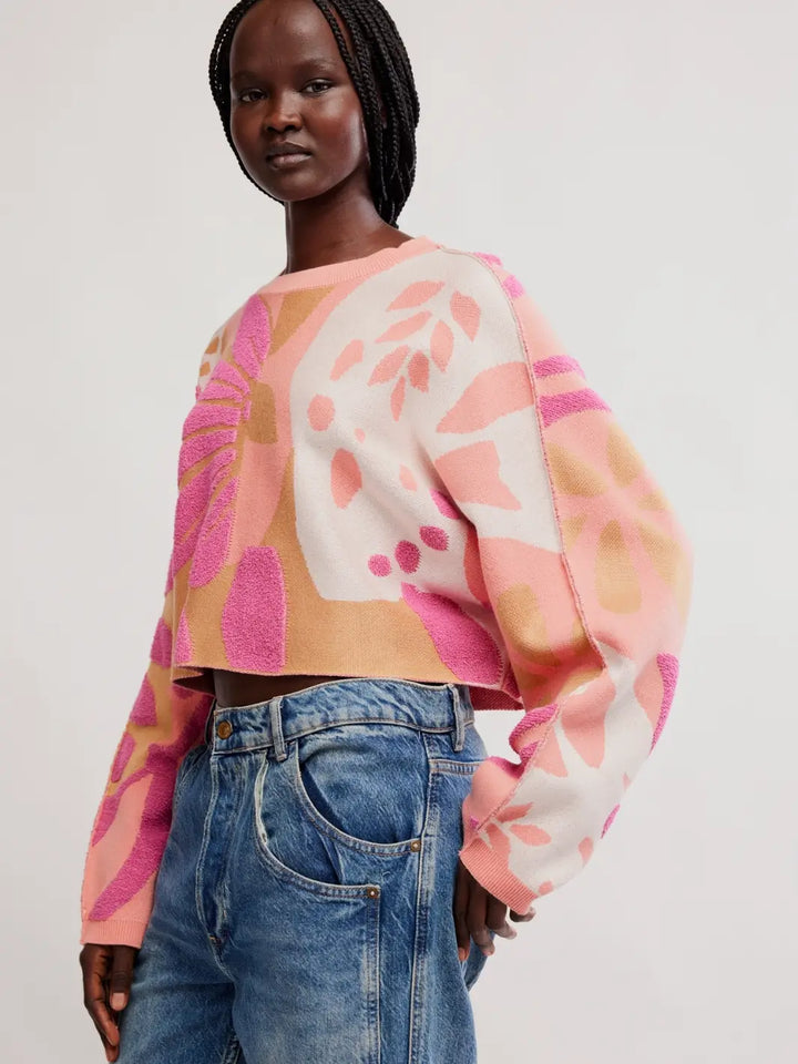 Side three-quarter view highlighting the relaxed drop-shoulder silhouette and floral pattern of the Free People Mia Pullover in Coral Kiss Combo | Twentyseven
