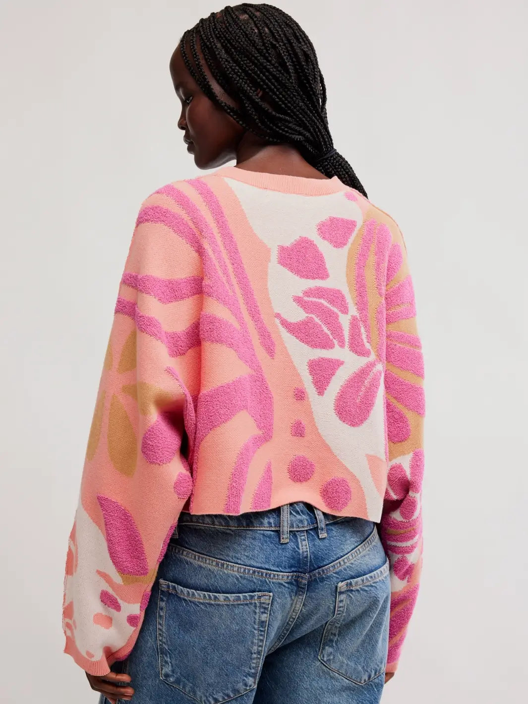 Back view showing the pink, orange, and cream floral knit print on the Free People Mia Pullover in Coral Kiss Combo | Twentyseven