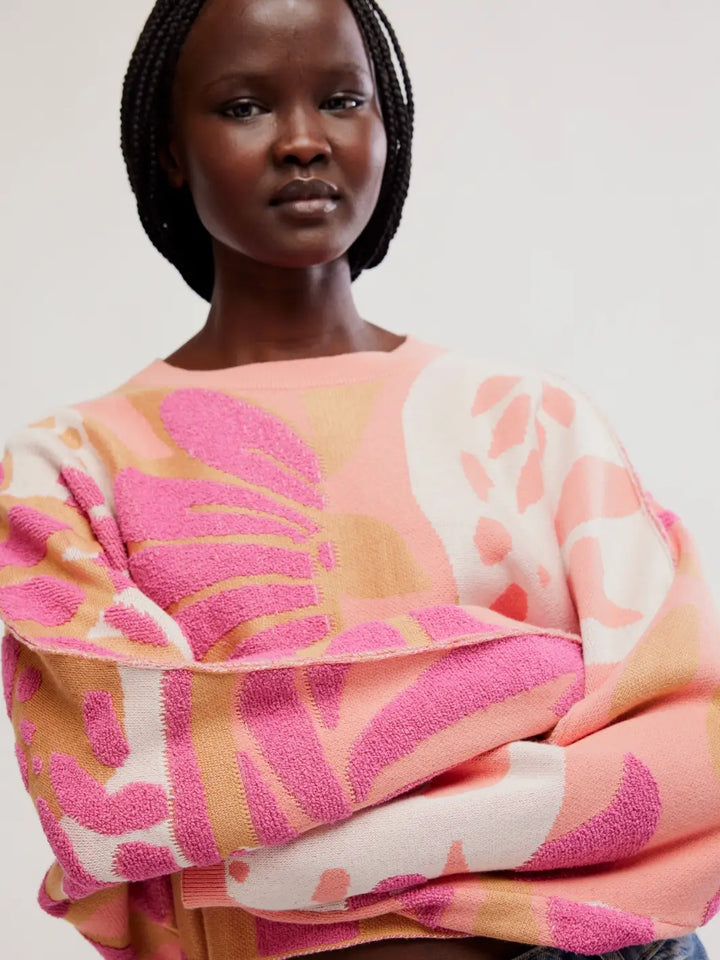 Close-up shot showing the textured knit finish and exposed seam detailing on the sleeves of the Free People Mia Pullover in Coral Kiss Combo | Twentyseven