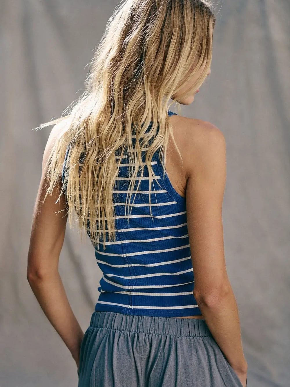 A back view highlights the high neckline, racerback silhouette, and fine ribbed texture of the Free People Mia Striped Tank - Navy Combo | Twentyseven Toronto