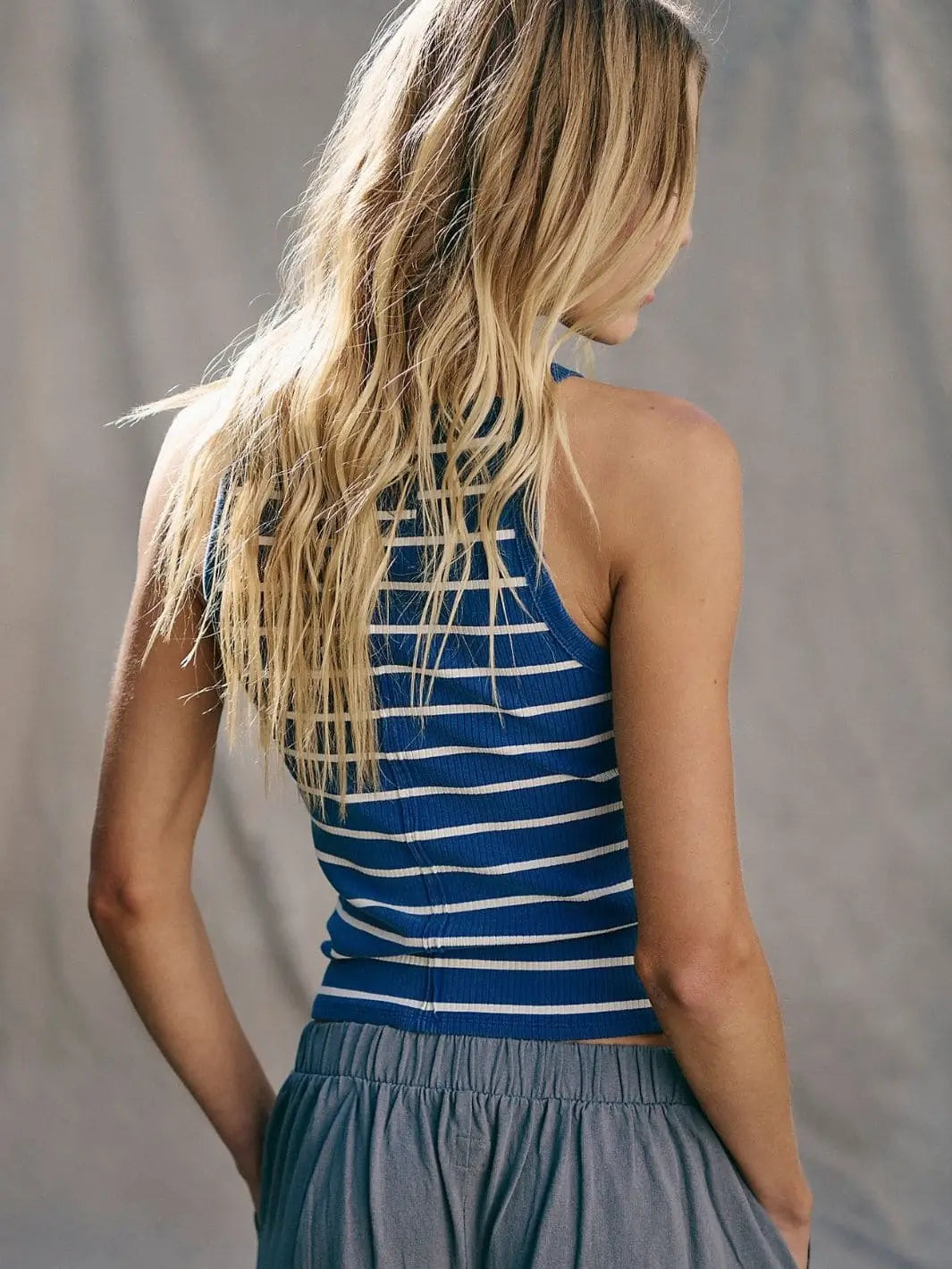 A back view highlights the high neckline, racerback silhouette, and fine ribbed texture of the Free People Mia Striped Tank - Navy Combo | Twentyseven Toronto