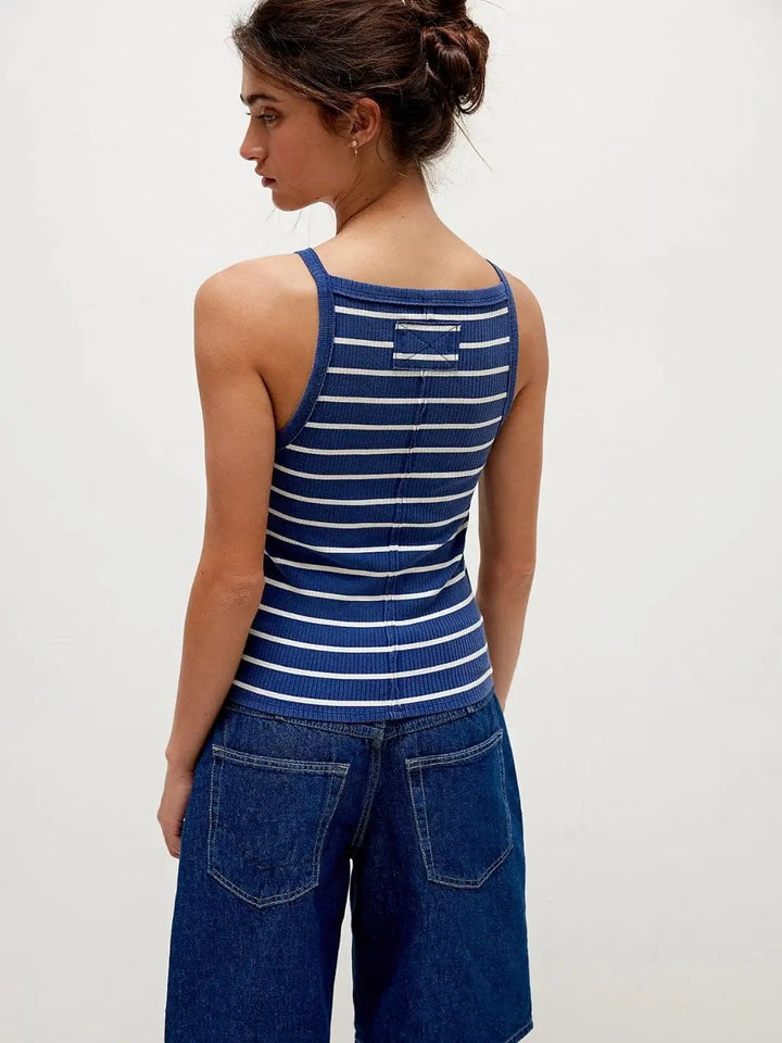 A rear view showcases the structured back seam and square-cut shoulders of the Free People Mia Striped Tank - Navy Combo styled with dark denim | Twentyseven Toronto