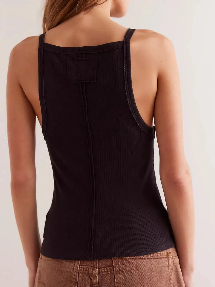 A view from behind highlights the low-cut back, raw-edge center seam, and small fabric logo patch of the ribbed Free People Mia Tank - Black | Twentyseven Toronto