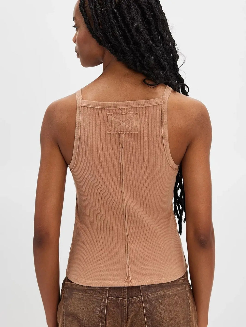 A back view highlights the low square-cut neckline, raw center seam, and small stitched fabric patch on the light brown Free People Mia Tank - Macchiato | Twentyseven Toronto