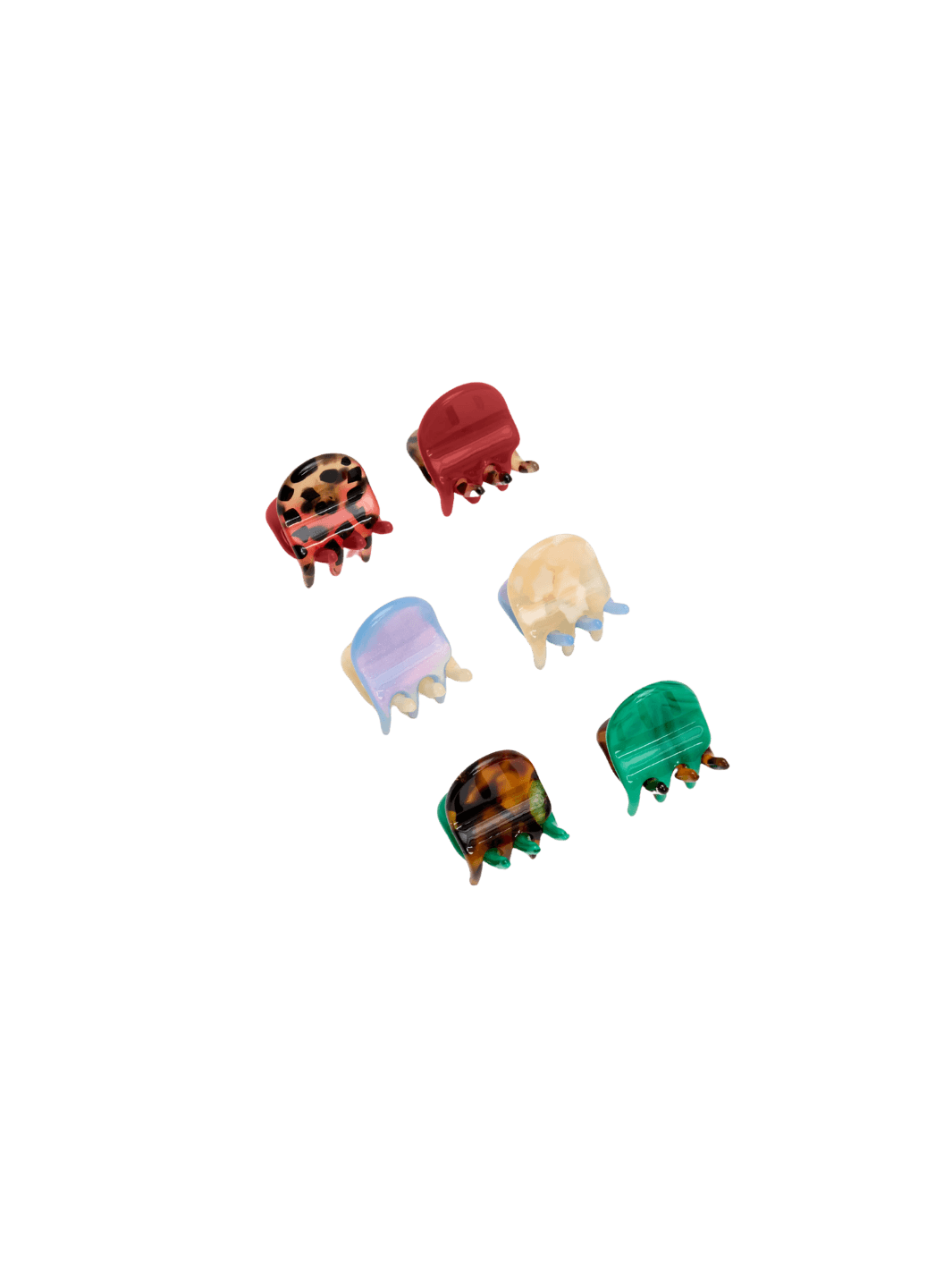 Six tiny, colorful claw clips from the Chunks Hairclips Micro Claws in Hot Mama set are arranged neatly against a transparent background | Twentyseven Toronto
