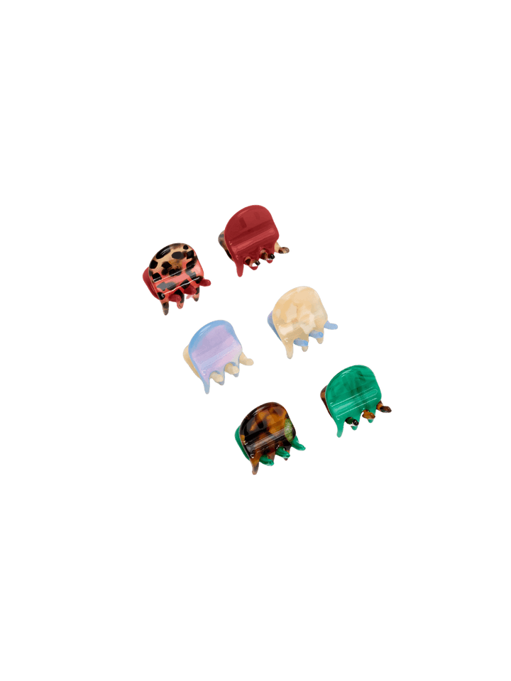 Six tiny, colorful claw clips from the Chunks Hairclips Micro Claws in Hot Mama set are arranged neatly against a transparent background | Twentyseven Toronto