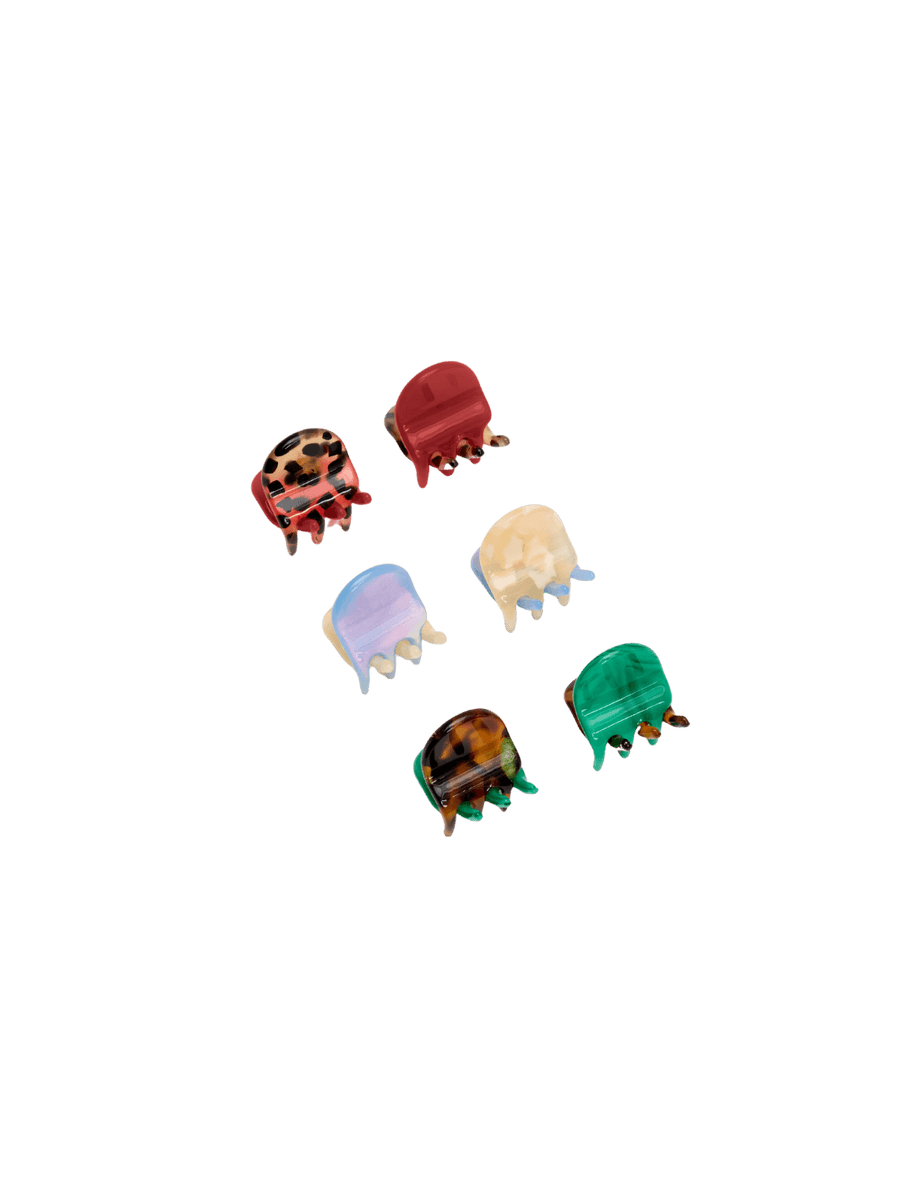 Six tiny, colorful claw clips from the Chunks Hairclips Micro Claws in Hot Mama set are arranged neatly against a transparent background | Twentyseven Toronto